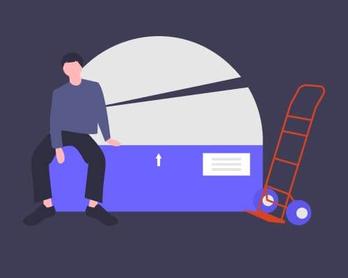 Guy sitting on a heavy box, with a trolly beside it.